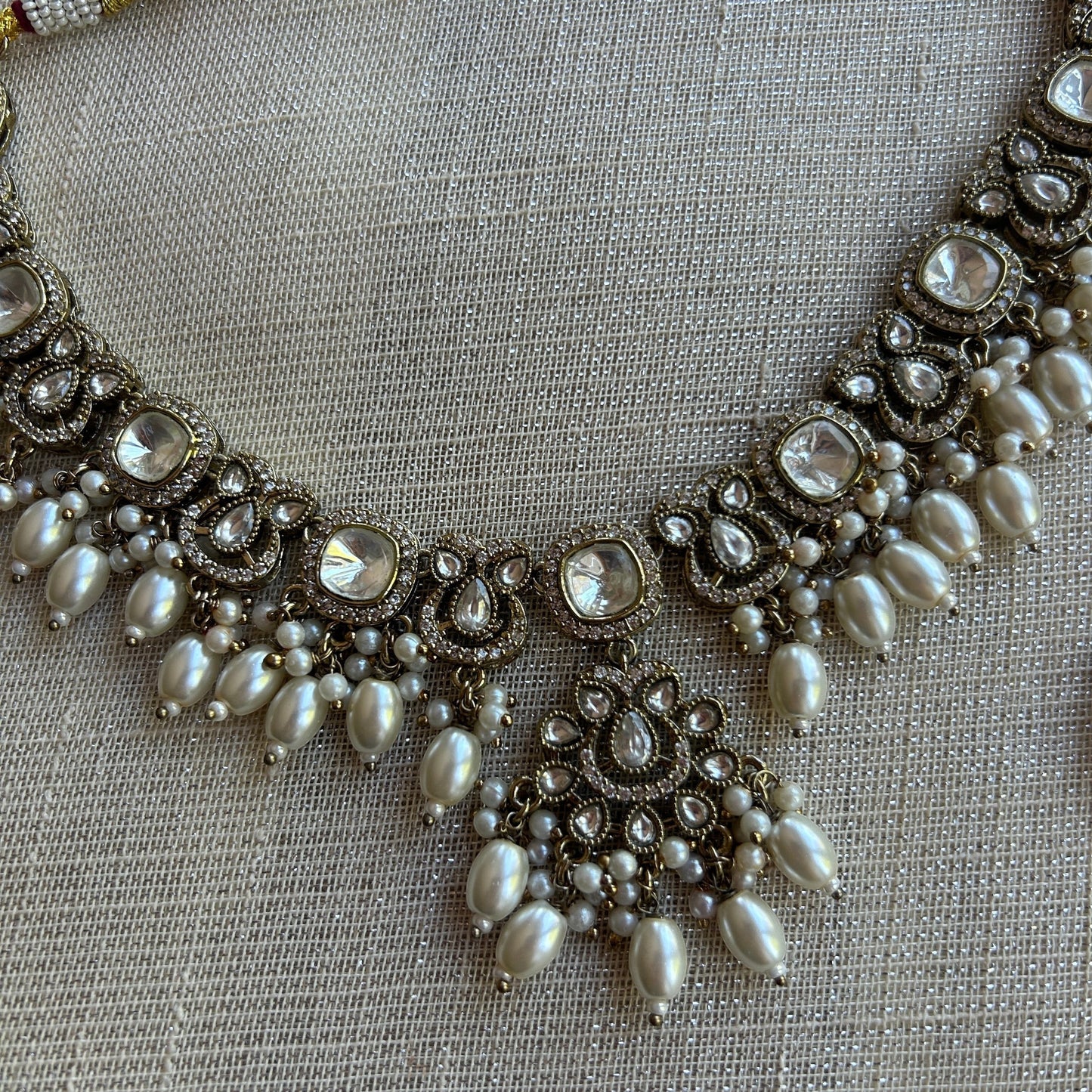 The Jewel Project antique gold necklace set with clear stones and pearls, matching Chandbali earrings.