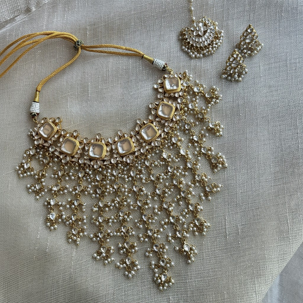 The Jewel Project GIGI LUXE KUNDAN SET necklace with pearl drops, tikka, and stud earrings. Gold tone with clear Kundan stones.