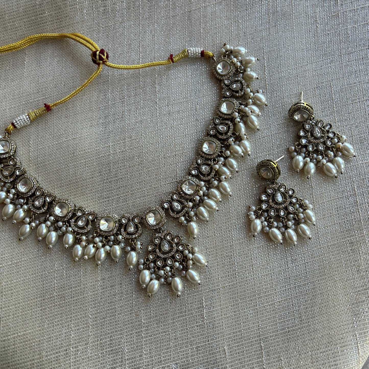 The Jewel Project silver pearl necklace set with matching Chandbali earrings, featuring clear stones and pearl drops.