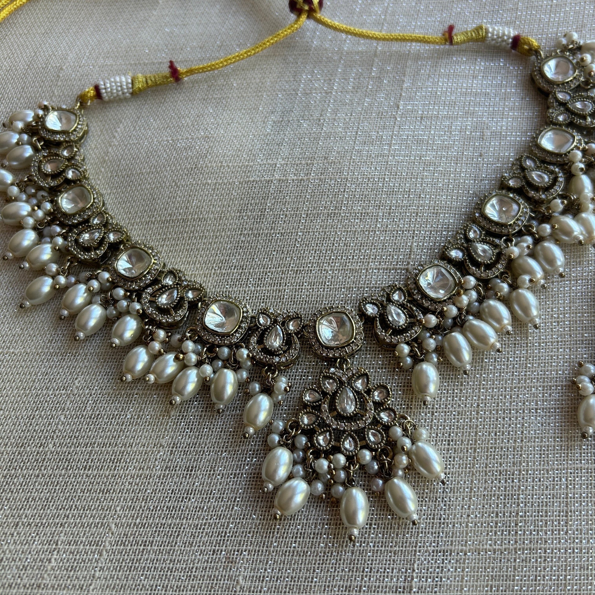 The Jewel Project antique silver necklace set with pearls and clear stones, includes matching Chandbali earrings.